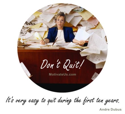 Inspirational Picture woman behind a desk with a hug stack of paper and wild hair