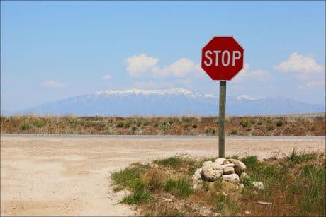 Stop and Decide- is it choices you make or fate stop sign on a desert road