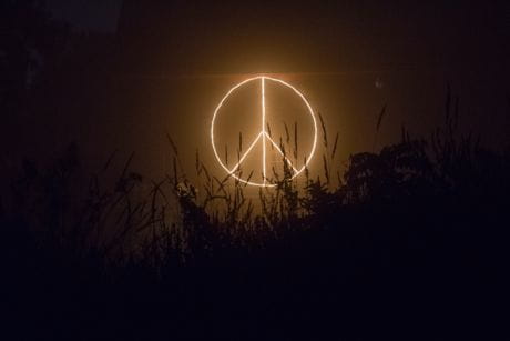 peace sign illuminated in the dark