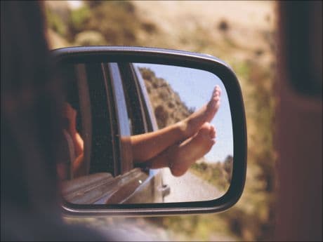 Inspirational Picture feet hanging out of a car window - representing a happier time.