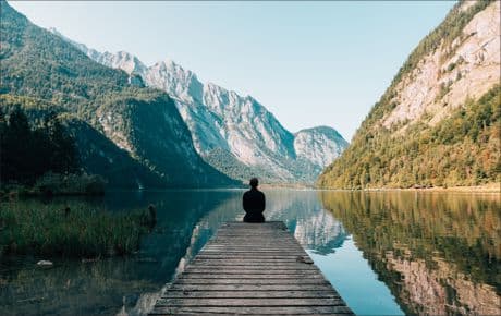 Inspirational Picture man on a dock looks like he's in contemplation or meditation